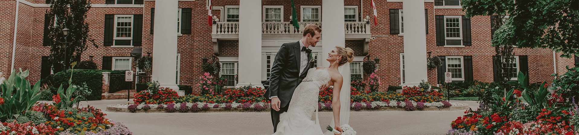 Married couple posing for photographs at the Queens Landing Hotel in Niagara-on-the-Lake