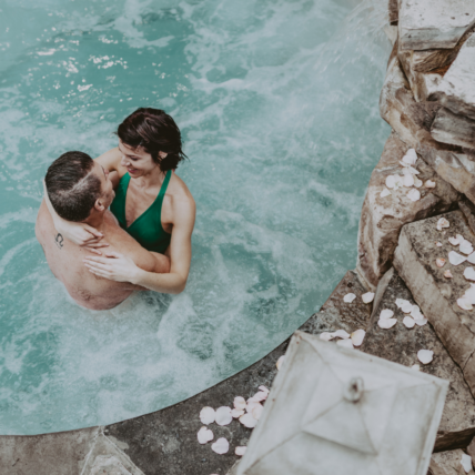 couple enjoying the outdoor hot spring pool at pillar and post