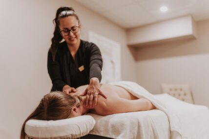 A woman receiving a massage at Spa On The Twenty.