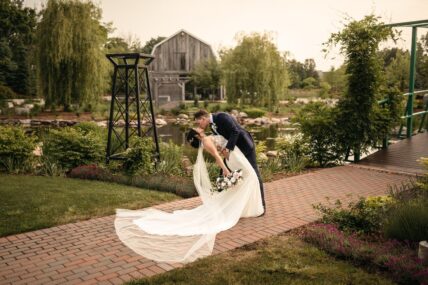 A couple kissing at Pont du Monet in The Gardens at Pillar and Post in Niagara-on-the-Lake.