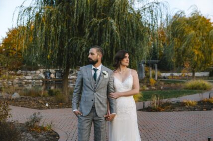 Newlyweds strolling through Le Petit Pavilion in The Gardens at Pillar and Post in Niagara-on-the-Lake.