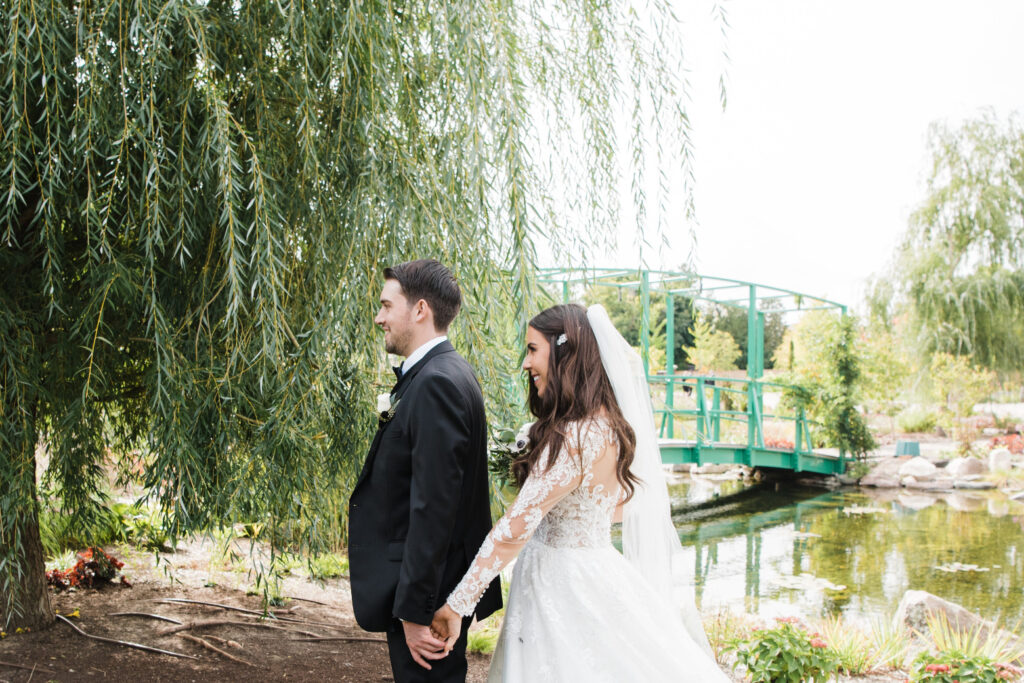 Bride and groom first look in The Gardens at Pillar and Post