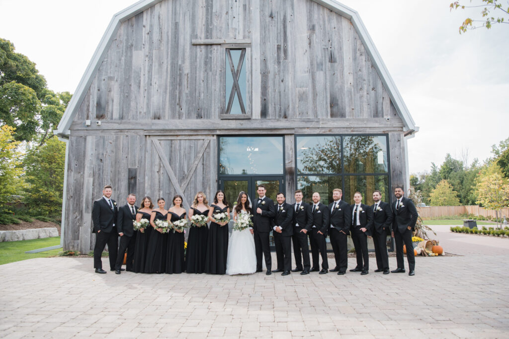 Wedding part in front of the Barn in The Gardens at Pillar and Post