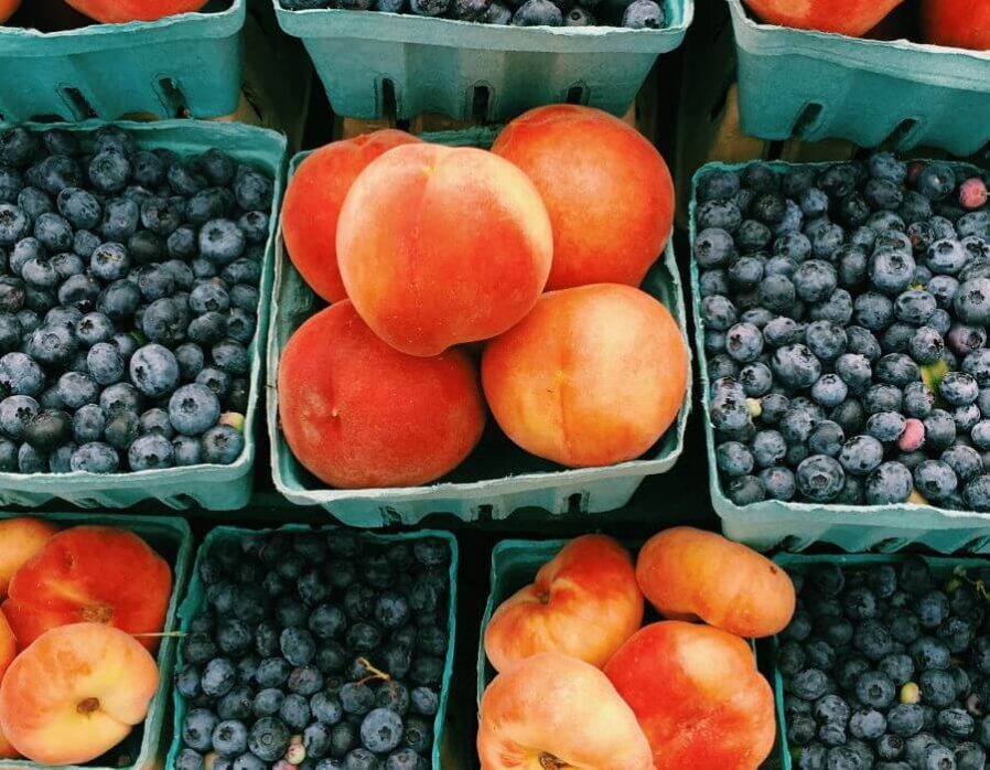 peaches and berries in baskets