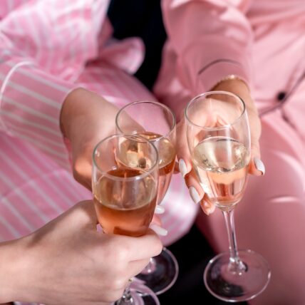 Friends cheering in pink pajamas as part of the Galentines getaway to Niagara-on-the-Lake