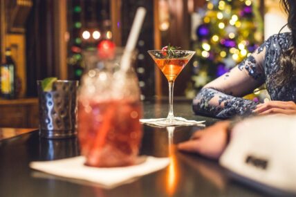 Guests of the Queen’s Landing hotel celebrating the New Year with drinks.