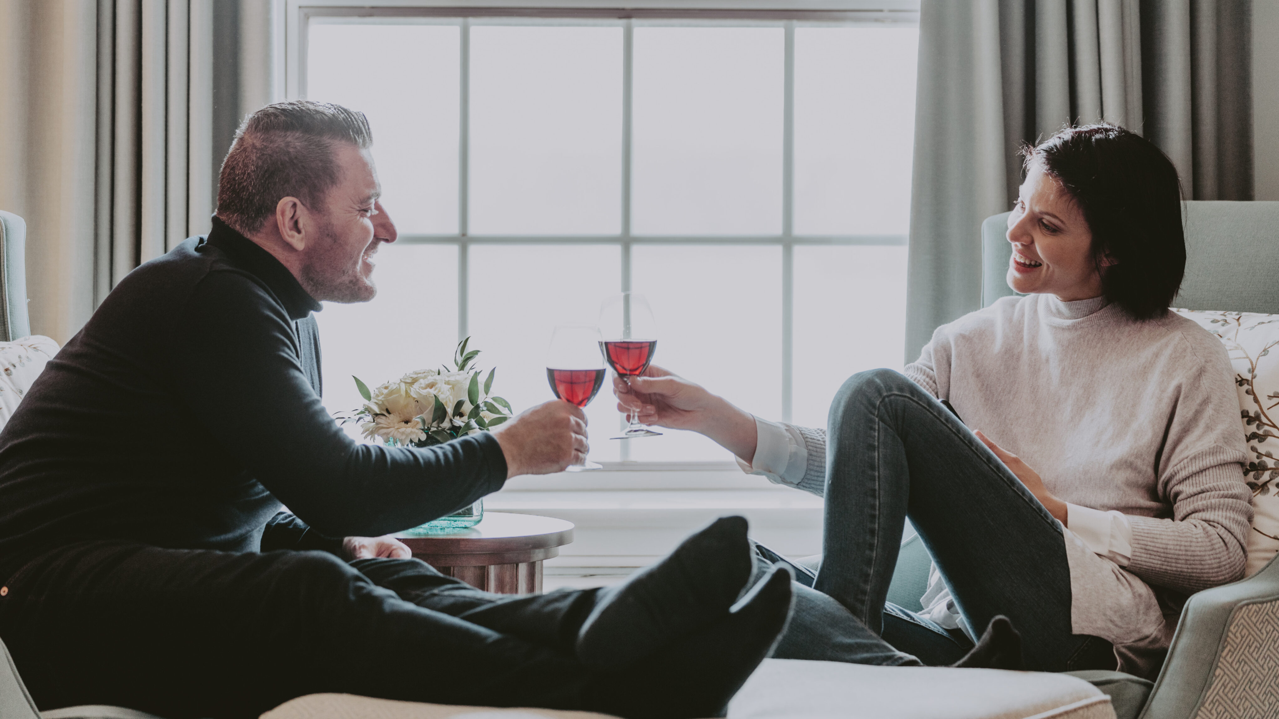 A couple unwinding in their room during a March Break getaway with Vintage Hotels.