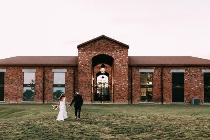 A couple walking through the grounds at The Hare Wine Co. in Niagara-on-the-Lake.