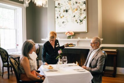 A couple being served a romantic dinner at HobNob Restaurant in Niagara-on-the-Lake.