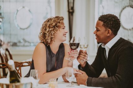 A couple holding hands during a romantic dinner at Noble Restaurant in Niagara-on-the-Lake.