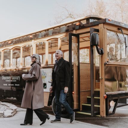 Couple departing the Vintage Hotel San Fransico-style trolly in Niagara-on-the-Lake