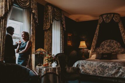 A couple toasting in their guestroom at the Prince of Wales hotel in Niagara-on-the-Lake.